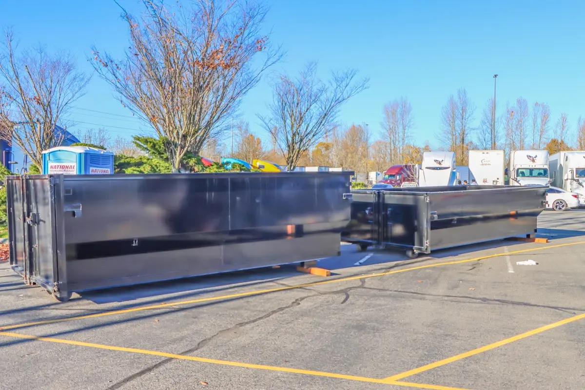 Professional dumpster rental service with roll-off container on residential driveway in Kingfisher